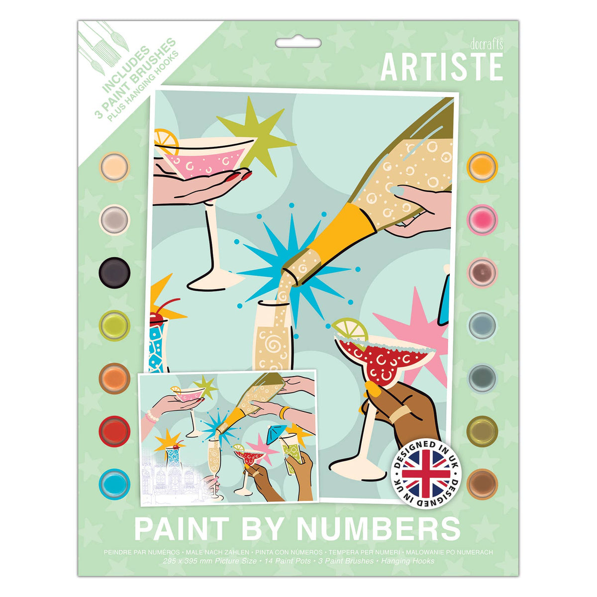 A packaged art and craft kit labeled 'kiff ARTISTE PAINT BY NUMBERS' showing a colorful cover illustration with cocktail glasses, champagne, and paint palette circles around the border.